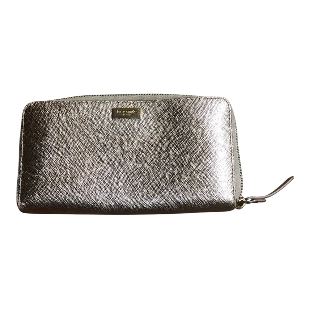 kate spade metallic silver zip-around wallet with gold logo